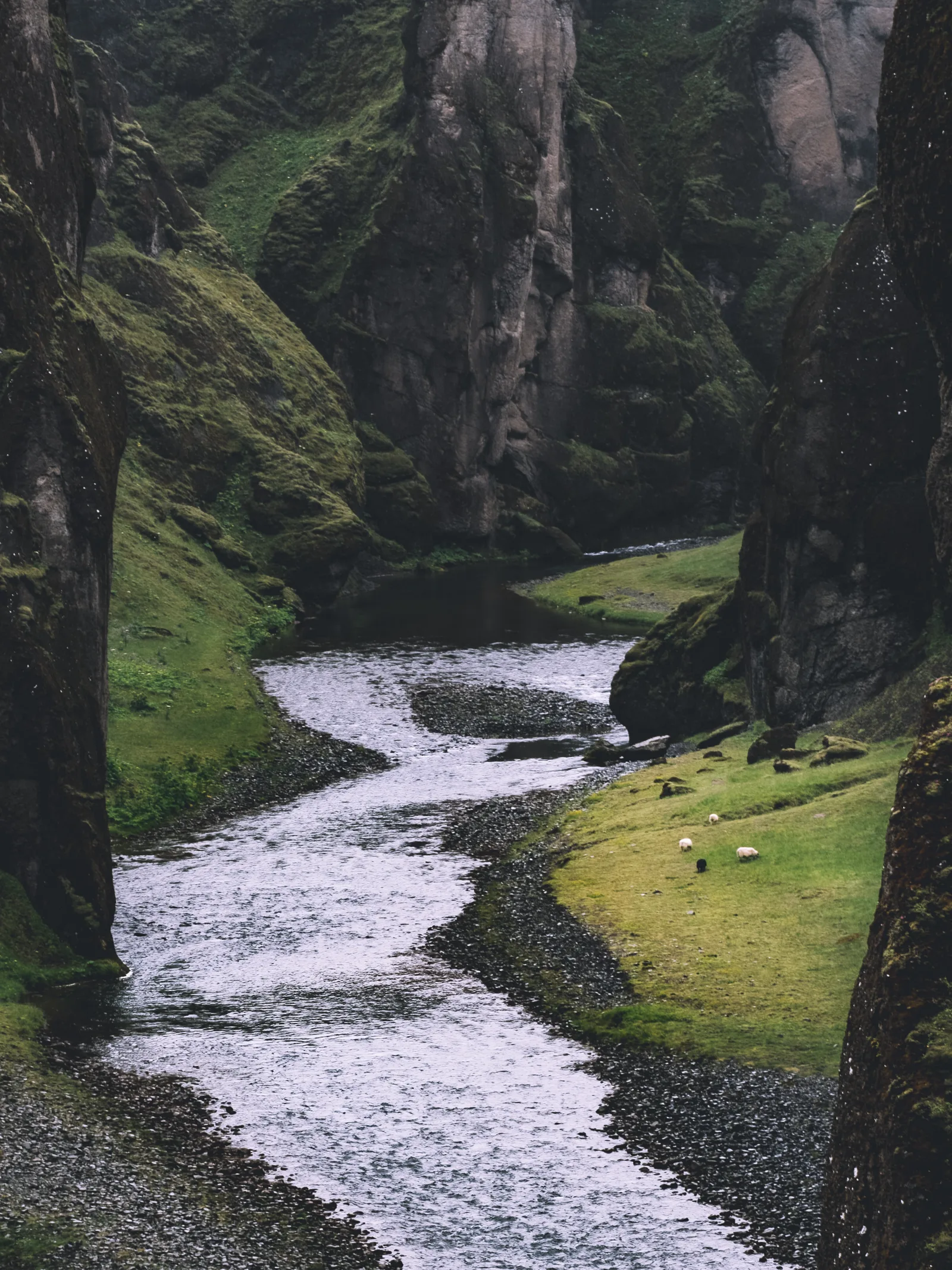 The deep river valley, green cliffs and river at Fjaðrárgljúfur canyon