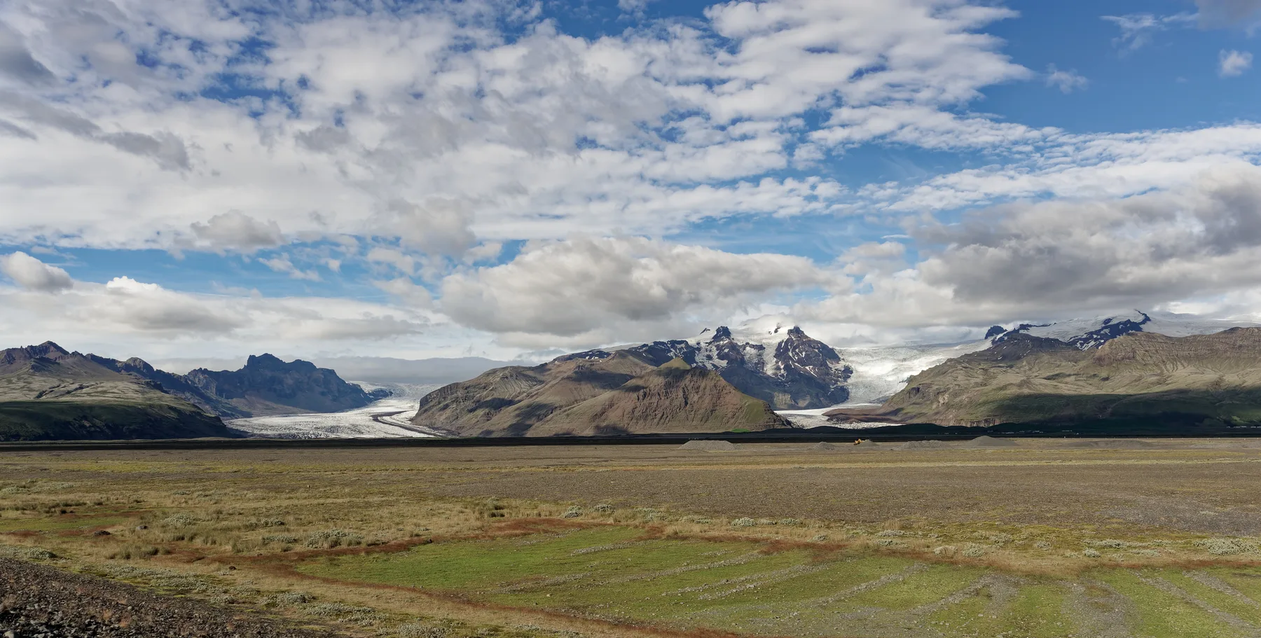 View of glacier and valley from Skaftafell trail direction, with vast gravel terrain in foreground