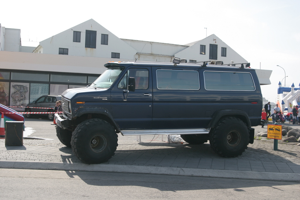 A tall modified off-road vehicle with wide tyres on an Icelandic street; the image illustrates vehicle scale only and does not represent a rental category, road eligibility or safety