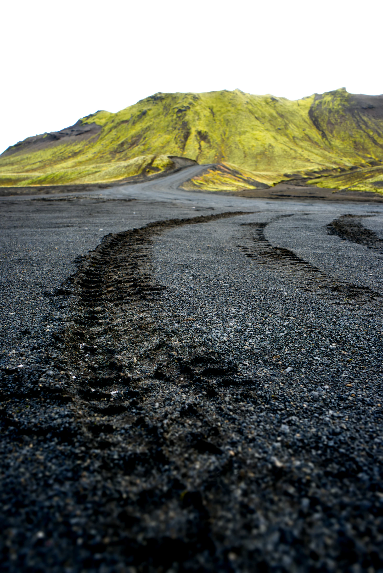 A gravel F208 road, tyre tracks and mountain terrain in Iceland's Highlands