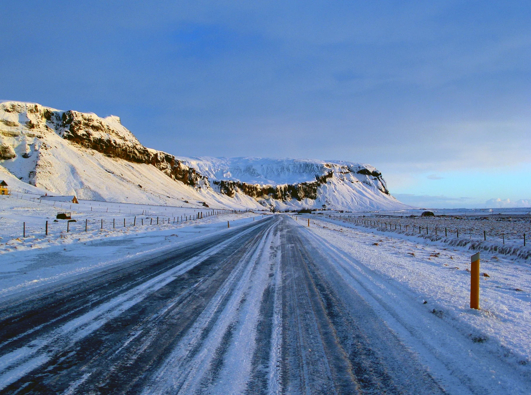 A winter view of an icy stretch of Route 1 between Vík and Höfn; shown only to convey road scale and seasonal risk, not the conditions or visibility on any particular day