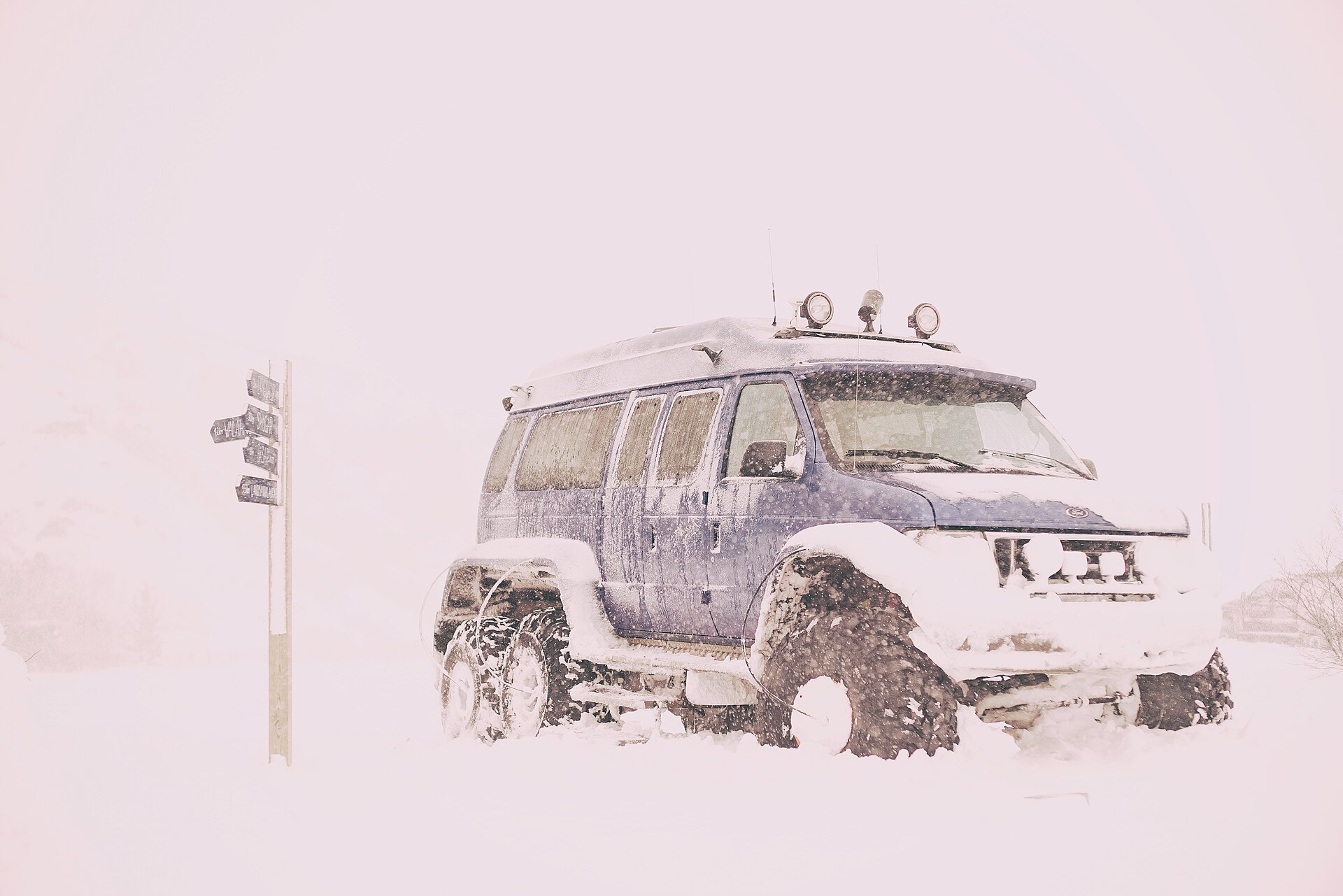A 4WD vehicle surrounded by snow in Iceland; the image illustrates a winter vehicle and visibility environment only, and does not represent any rental company's equipment or current road conditions