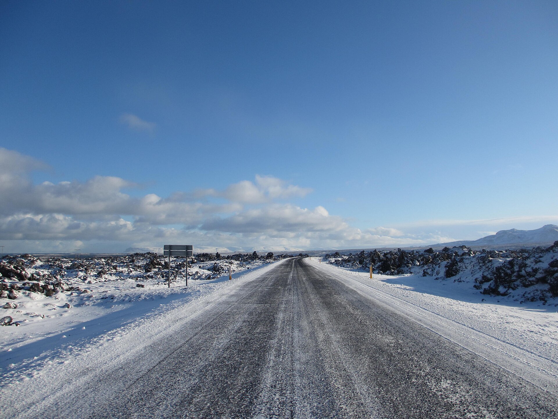 A real road and mountain view on Iceland's Snæfellsnes Peninsula; it does not represent conditions in Arnarstapi on any particular day