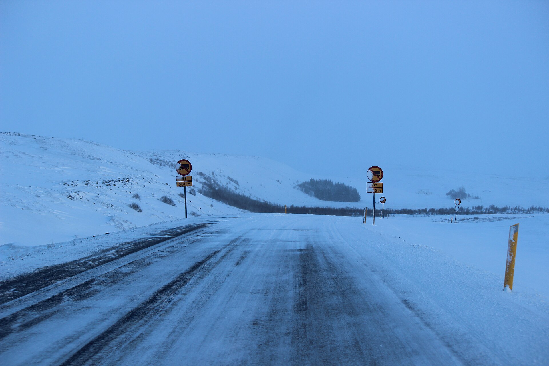A snowy stretch of Route 1 and distant terrain in winter Iceland